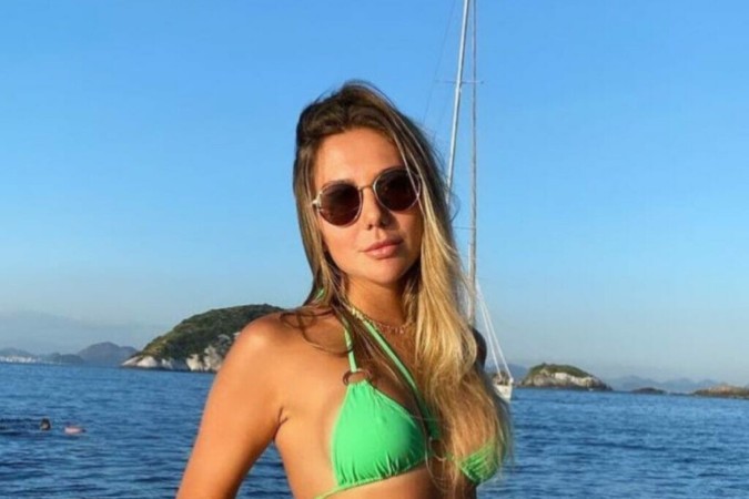 De biquíni verde, Carolina Portaluppi senta no cantinho do barco e ostenta beleza -  (crédito: Observatório dos Famosos)